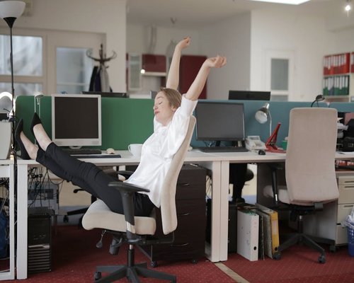 Indian professional doing light stretching at office chair