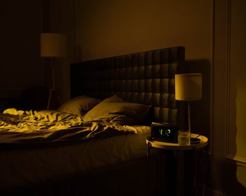 Peaceful dim lit bedroom indicating time to sleep
